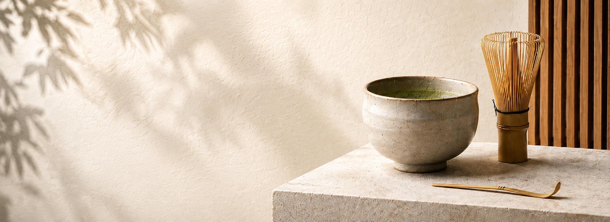 Matcha bowl and bamboo whisk on a stone table